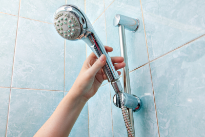 close-up wall mounted hand shower and hose holder with height adjustable bar slider rail