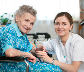 nurse and elder woman smiling